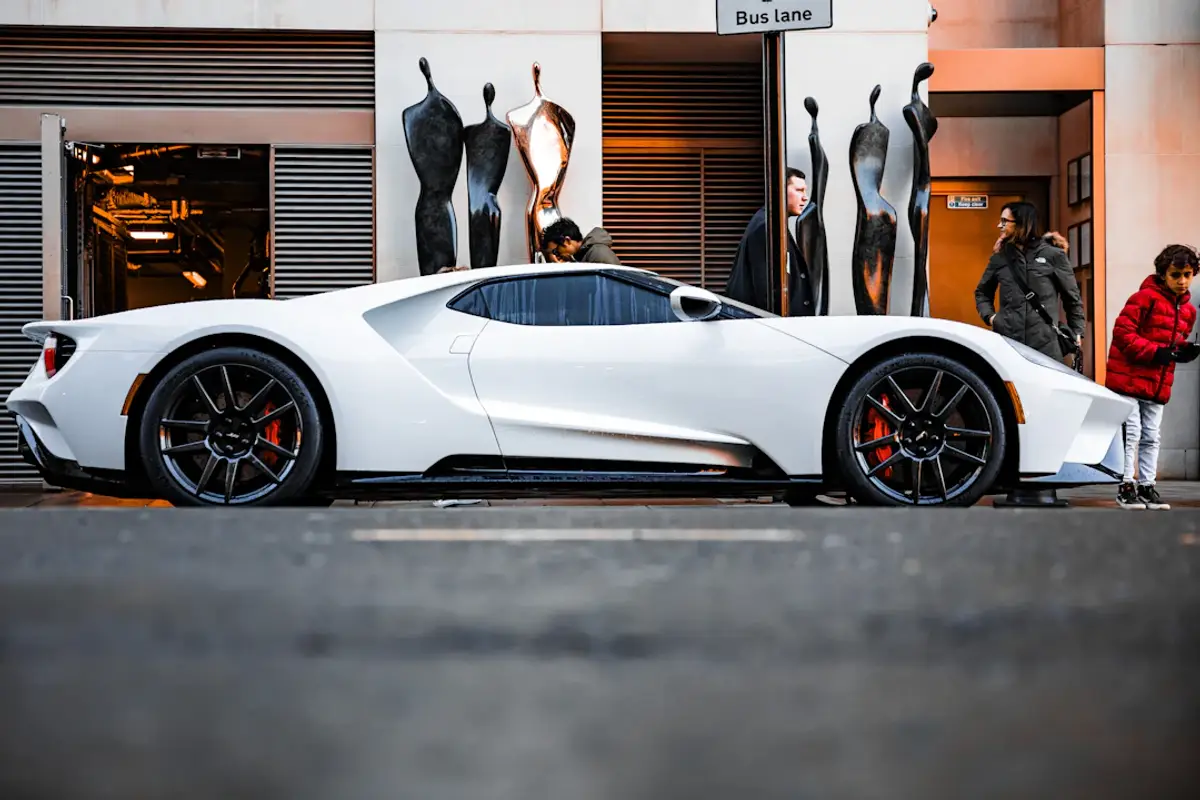 a white sports car parked in front of a building