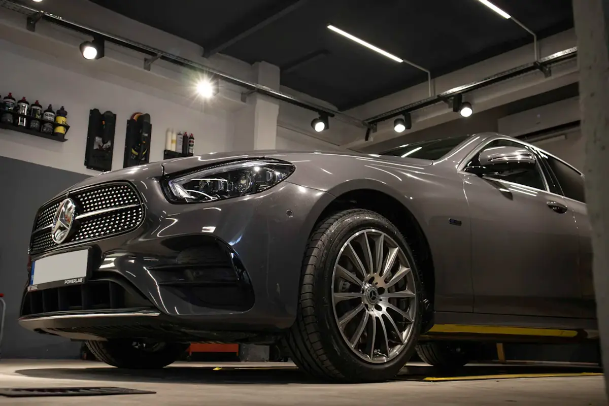 a car is parked in a garage with lights on