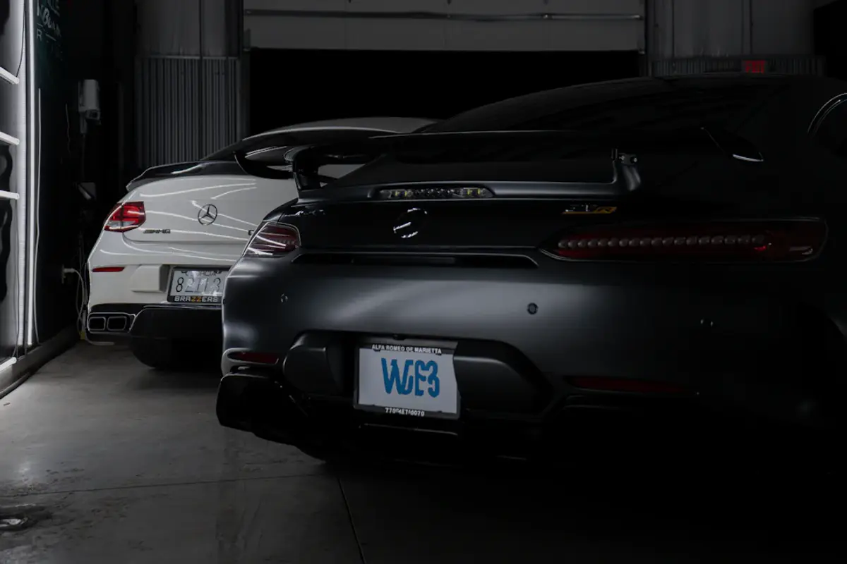 A couple of cars are parked in a garage